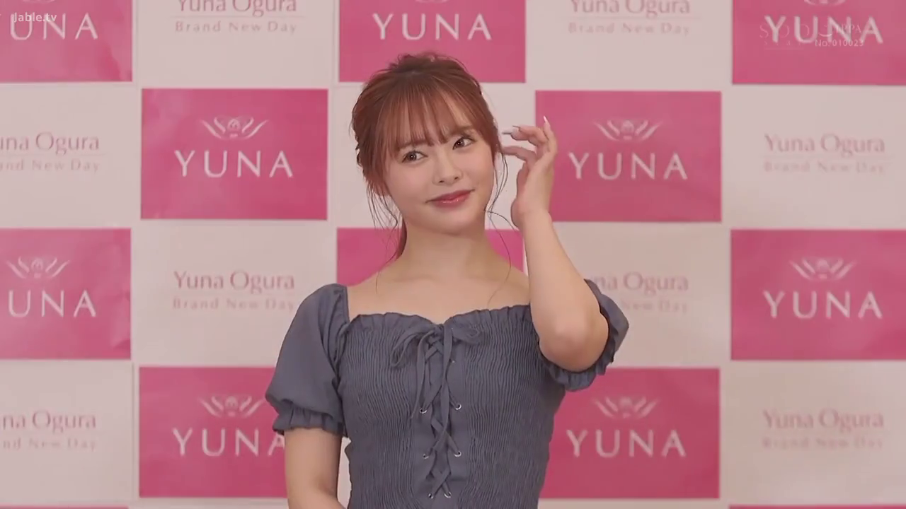 微笑 · 半身 · 撩发 · 背景板 · 侧身站立 · 女优写真 · 活动现场 · 灰色露肩衫